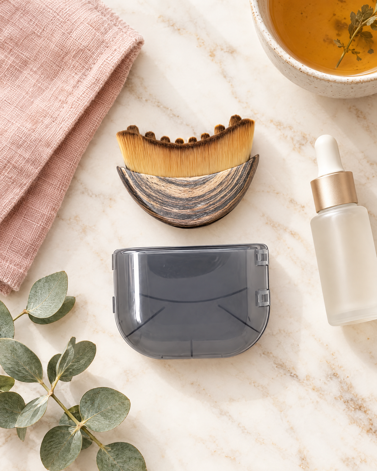 Sculpt Brush with lid, serum and towel on marble